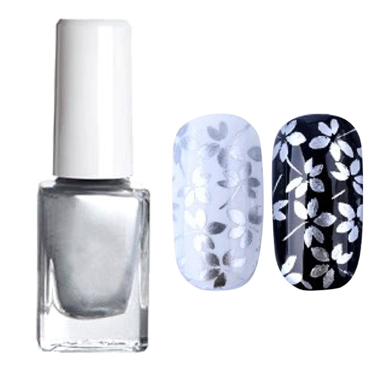 Silver nail art stamping polish with white cap, shown with silver floral stamped designs on pale blue and black nail tips for detailed manicure art