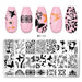 Nail stamping plate with black floral and butterfly patterns, shown below four pink nail tips decorated with the designs. Product code BC-12 is printed near the tips and on the plate.