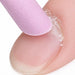 Close-up of a pink stone cuticle file exfoliating dry cuticle around a natural fingernail