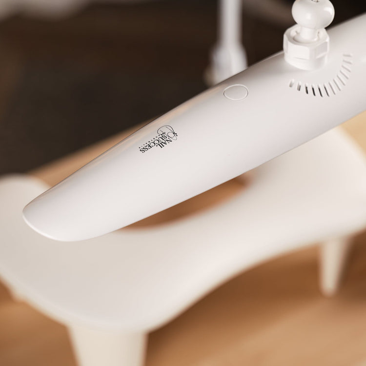 Nail Success Australia StudioFlex nail desk lamp — close-up of slim white LED panel with touch button above manicure hand rest