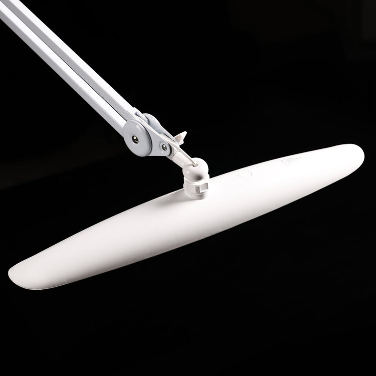 Nail Success Australia StudioFlex LED nail desk lamp — close-up of adjustable arm and tilting panel head on black background