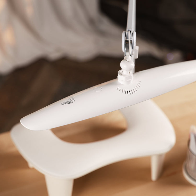 Nail Success Australia StudioFlex nail desk lamp — close-up of slim white LED panel with touch button and vents above manicure hand rest