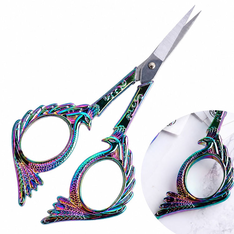 Rainbow stylish bird nail scissors close-up with ornate iridescent handles and sharp blades, NSI Australia