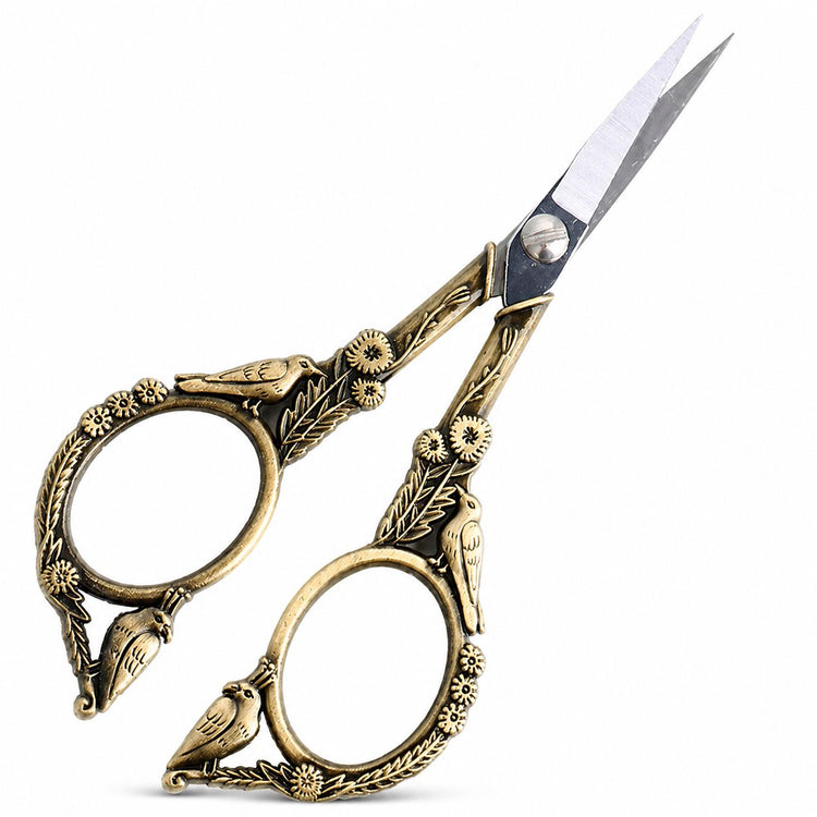Bronze stylish bird nail scissors shown from side angle with open blades and ornate bird floral handles, NSI Australia