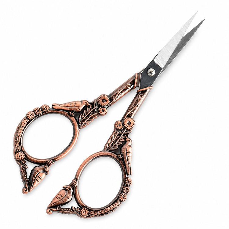 Copper stylish bird nail scissors shown from side angle with sharp blades and ornate bird floral handles, NSI Australia