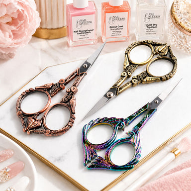Copper, gold and rainbow stylish bird nail scissors displayed with Nail Success manicure products and salon accessories, NSI Australia