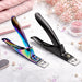 Rainbow and matte black nail tip cutters displayed on a marble beauty surface with pink towels, crystals and manicure accessories