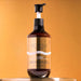 Voesh 24K Gold vegan hand and body crème pump bottle on gold background