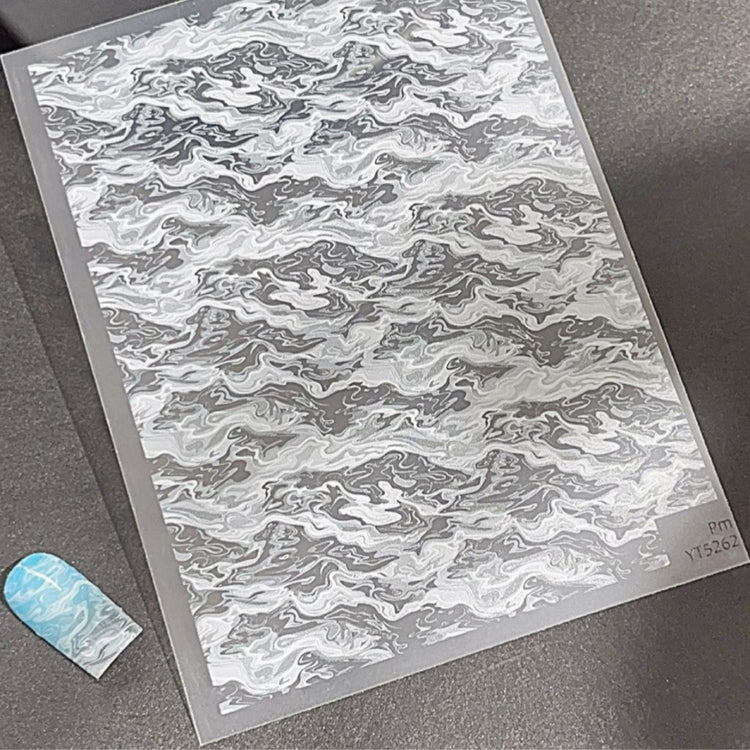 Marble wave nail art sticker sheet with grey and white swirl pattern, shown with blue marbled nail sample