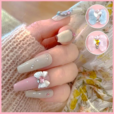 Crystal heart nail art with butterfly and glitter encapsulation. 